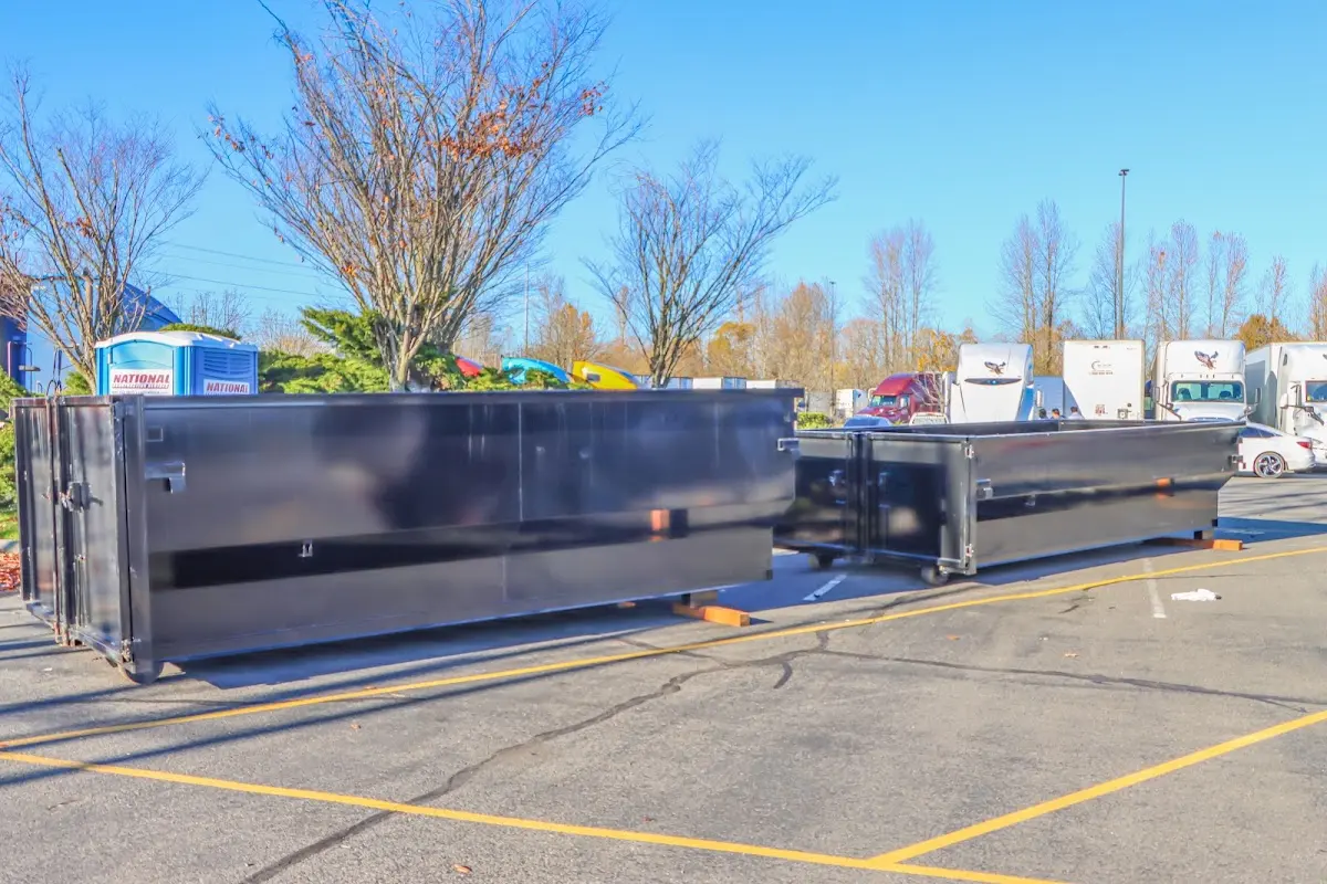 Professional dumpster rental service with roll-off container on residential driveway in Wilsonville